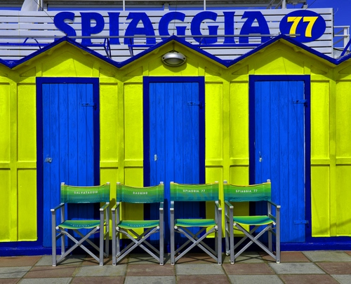 Immagine con cabine, sedie, giallo, blu, spiaggia, porte, insegna